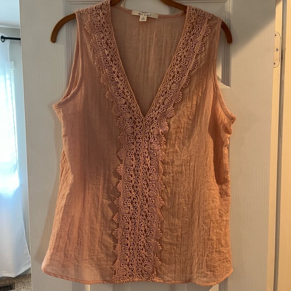 Sleeveless, peach top, embroidery detail on front